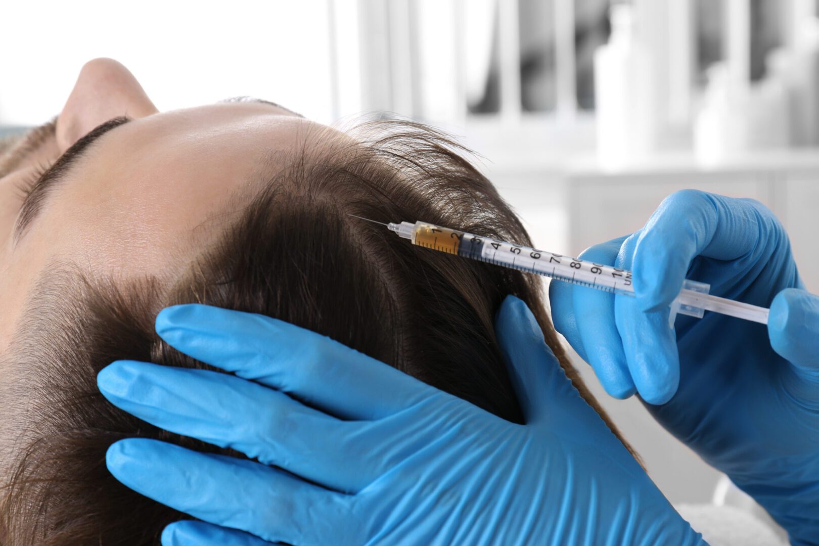 A person getting their hair cut with an injection.