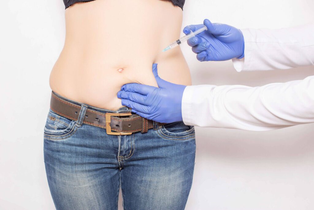 A person is getting their belly button checked by an expert.